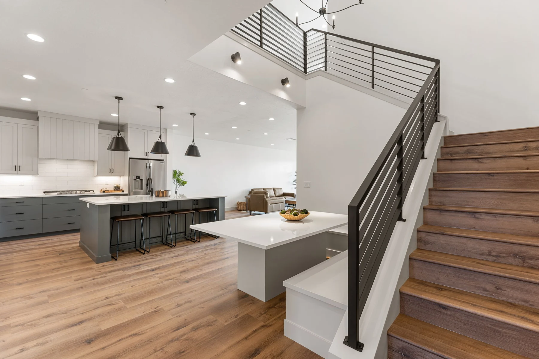 Open-plan kitchen and staircase at Isle 64 – Isle 64 vacation rental in Washington, Utah near St. George and Zion