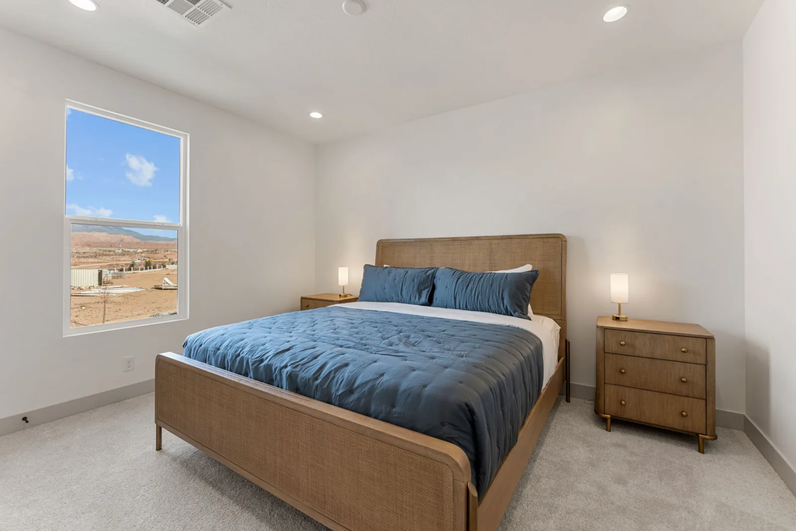 Isle 64 king suite with cane headboard and slate-blue bedding